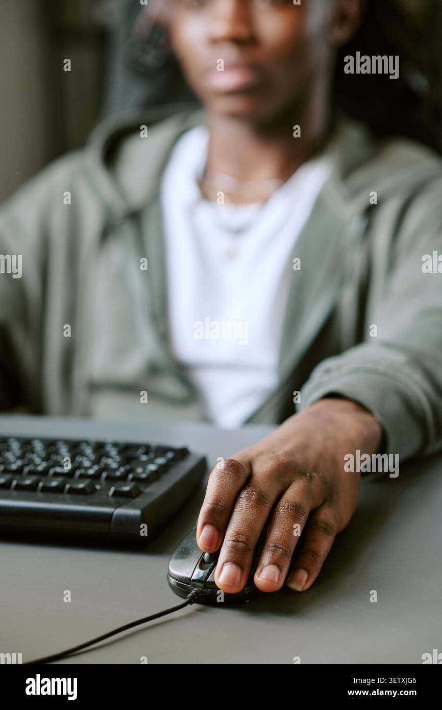 Unrecognizable Man Using Computer Mouse for Online Learning Stock Photo