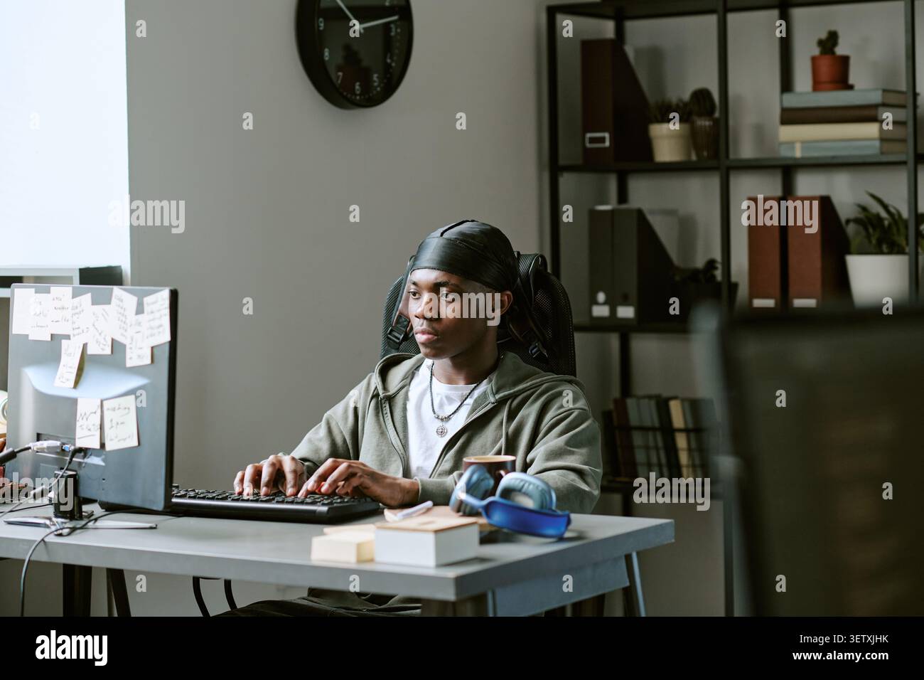 Black Man Working at Desktop Computer in Home Office Stock Photo