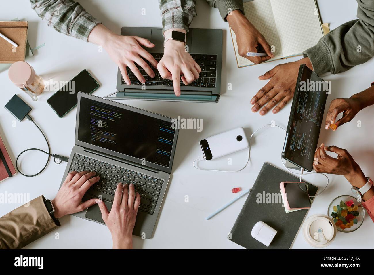 Diverse Team Collaborating on Software Development at Workspace Stock Photo