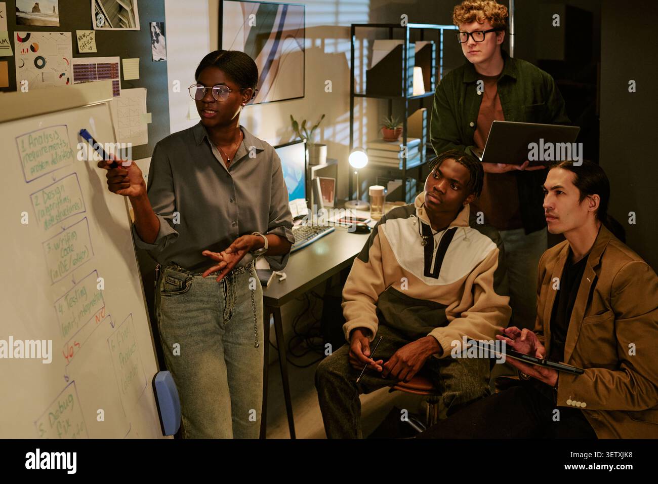 Black Woman Leading Creative Team Brainstorming in Office Stock Photo