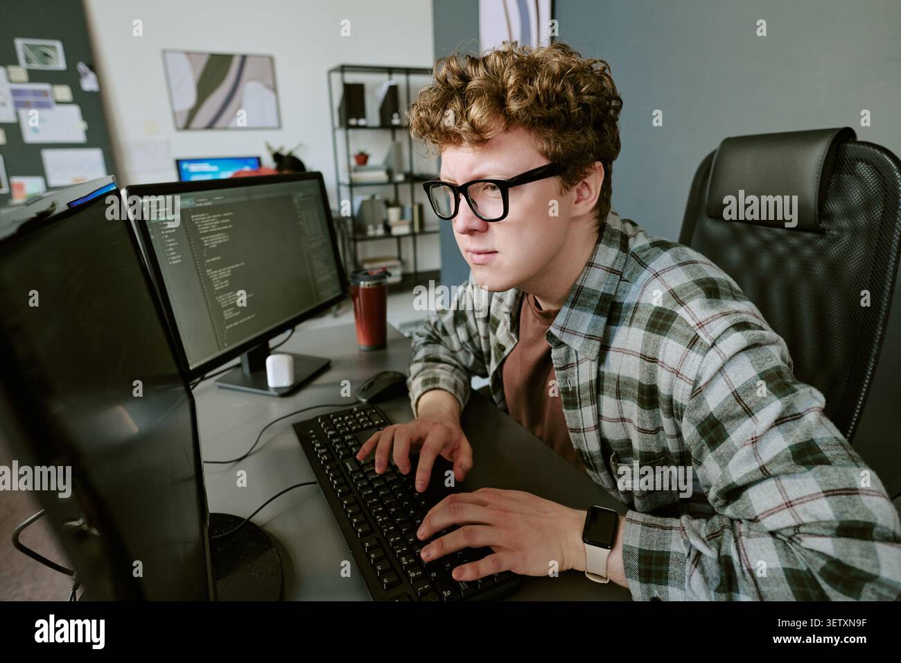 Adult Man Coding at Desk for Software Development Project Stock Photo