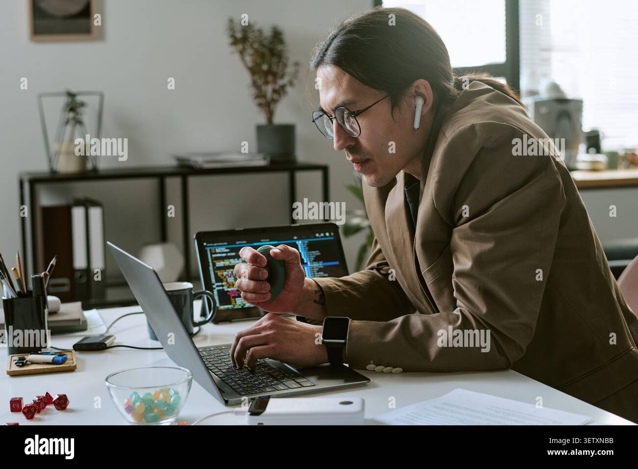 Asian Man Working on Laptop during Software Development Stock Photo