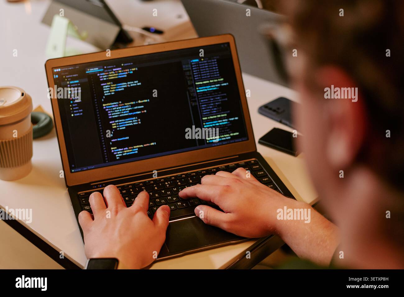 Adult Man Coding on Laptop for Software Development Workflow Stock Photo