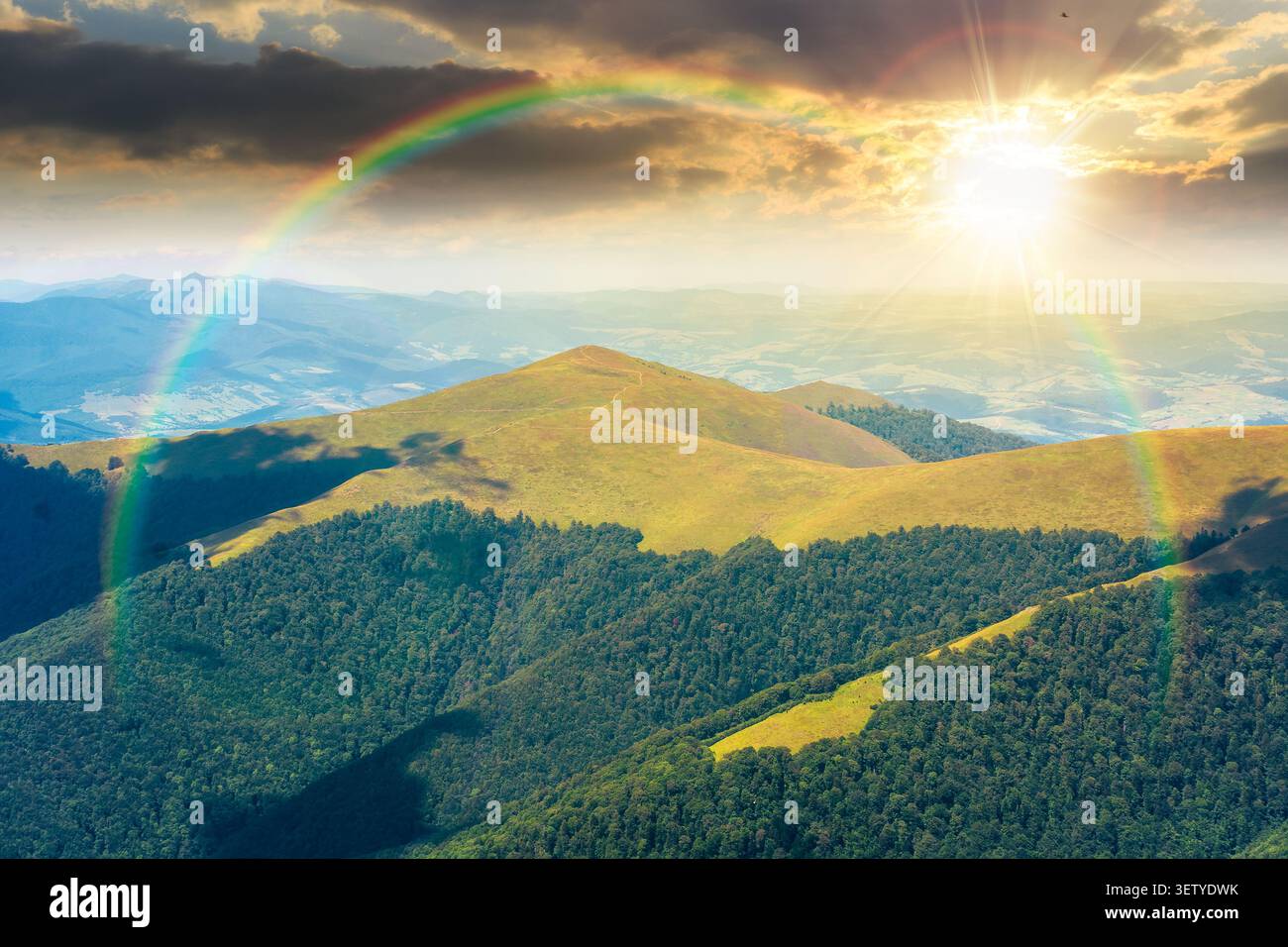 sunset over beautiful mountain landscape in summer. travel ukraine background. rolling hill in dappled light. scenic view of borzhava ridge. carpathia Stock Photo