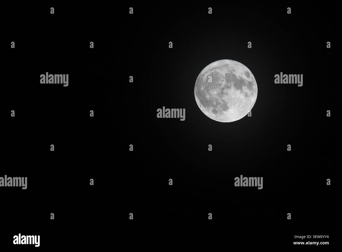 A bright full moon against a black-night sky. Stock Photo