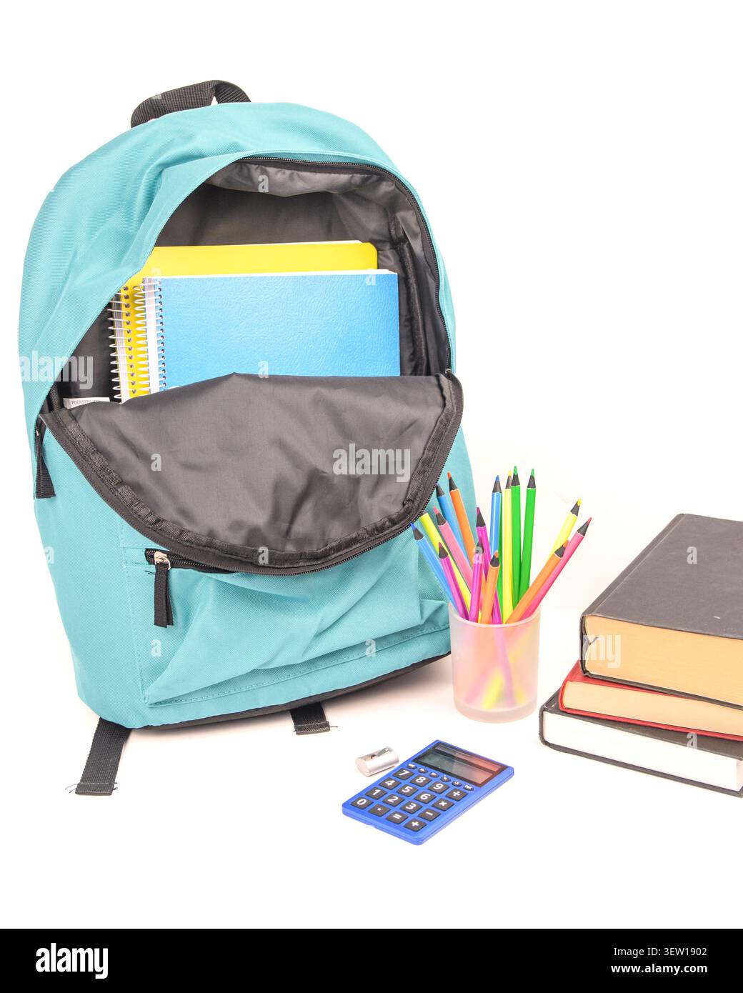Open turquoise backpack with notebooks, colored pencils, calculator, eraser, sharpener and books on a clean white background for back to school. Stock Photo