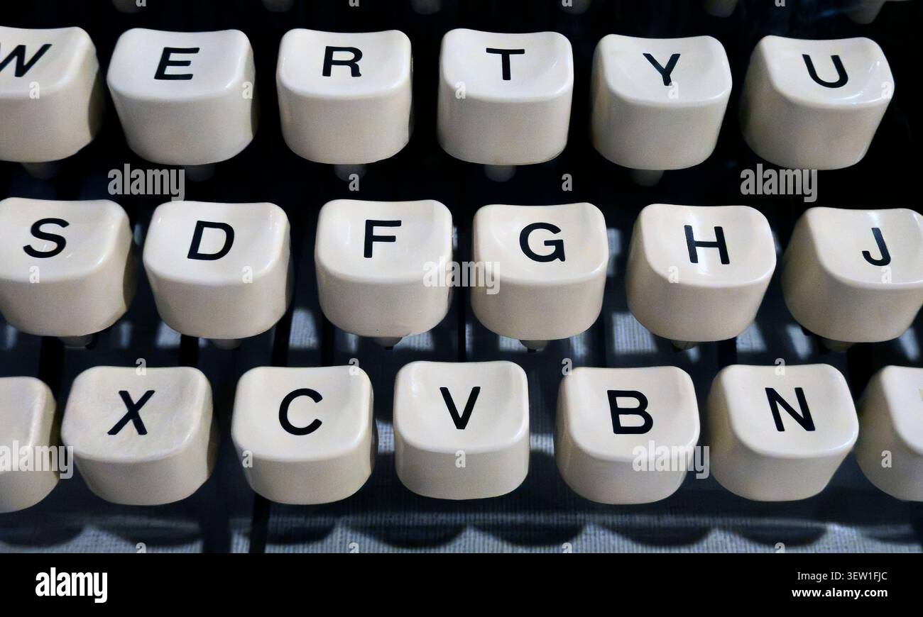 Close-up of vintage typewriter keyboard with round keys and QWERTY layout Stock Photo