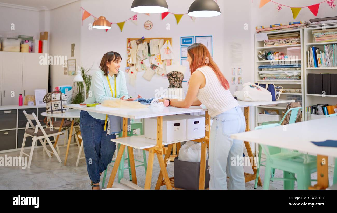 Women collaborating in a creative sewing workshop Stock Photo