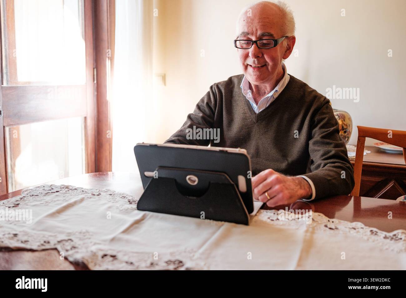 Senior man learning and enjoying digital technology at home Stock Photo