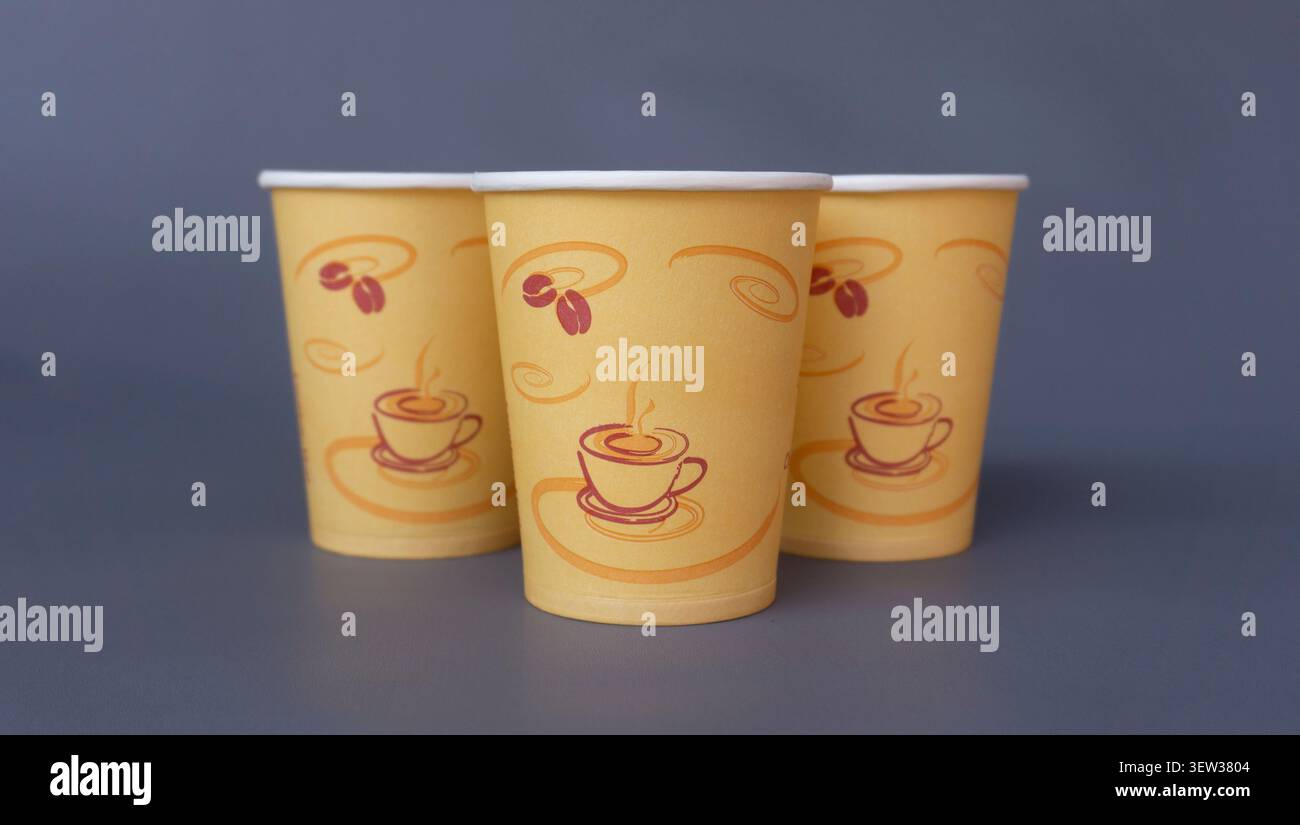 Three Disposable Coffee Paper Cups on Dark Gray Background Stock Photo