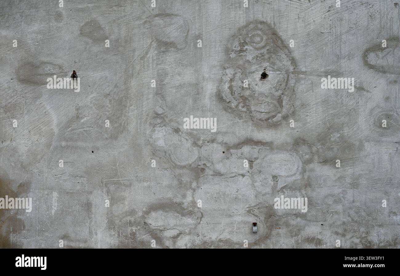 Close up horizontal view of a weathered concrete wall surface with rough texture, water spots Stock Photo