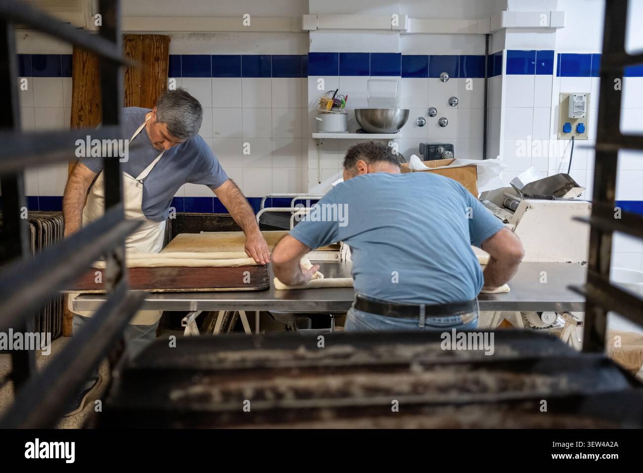 Bakers preparing bread dough in a professional kitchen Stock Photo
