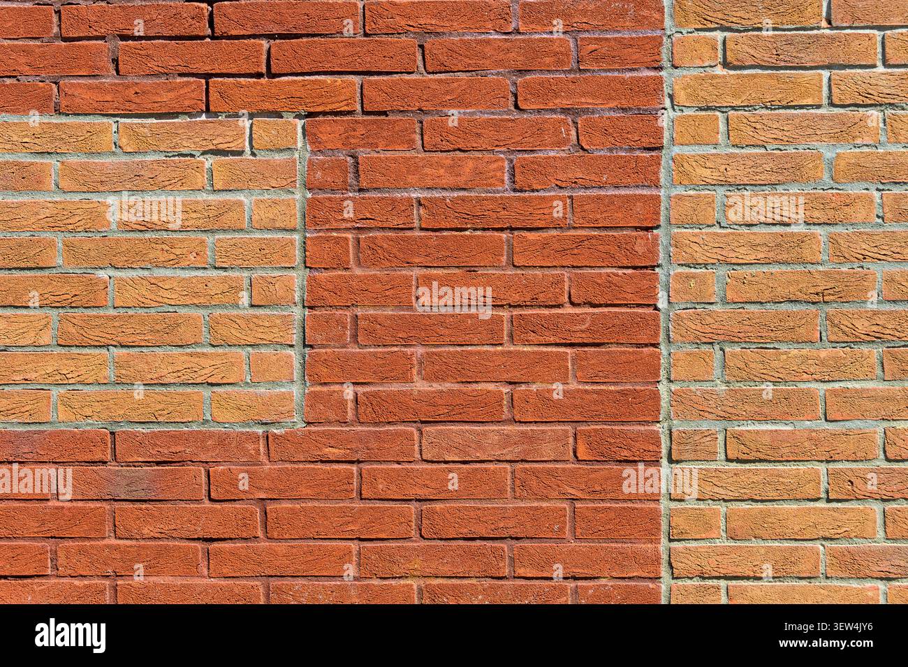 red brick wall with contrasting brick patches Stock Photo