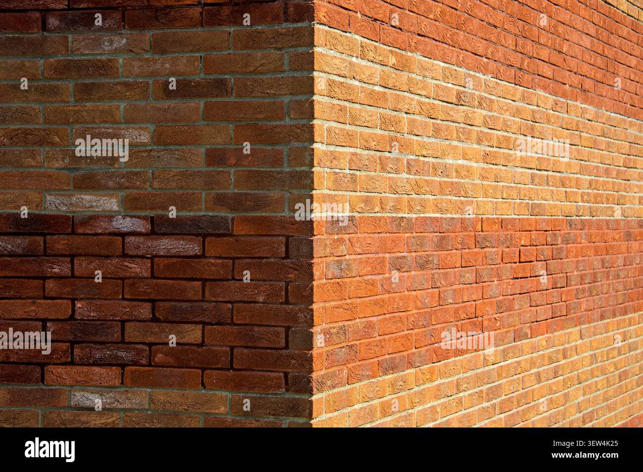 Red Brick Wall Corner With Textured Masonry, Sunlight and Shadow Stock Photo