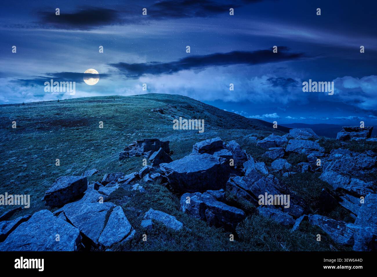 carpathian mountain landscape on summer night. mysterious background for outdoor adventure in the dark. transcarpathia green hill with rocks in foll m Stock Photo