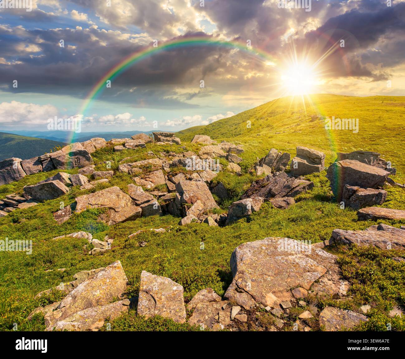 sunset over carpathian mountain landscape in summer. nice background for outdoor adventure in evening light. transcarpathia green hill with rocks Stock Photo