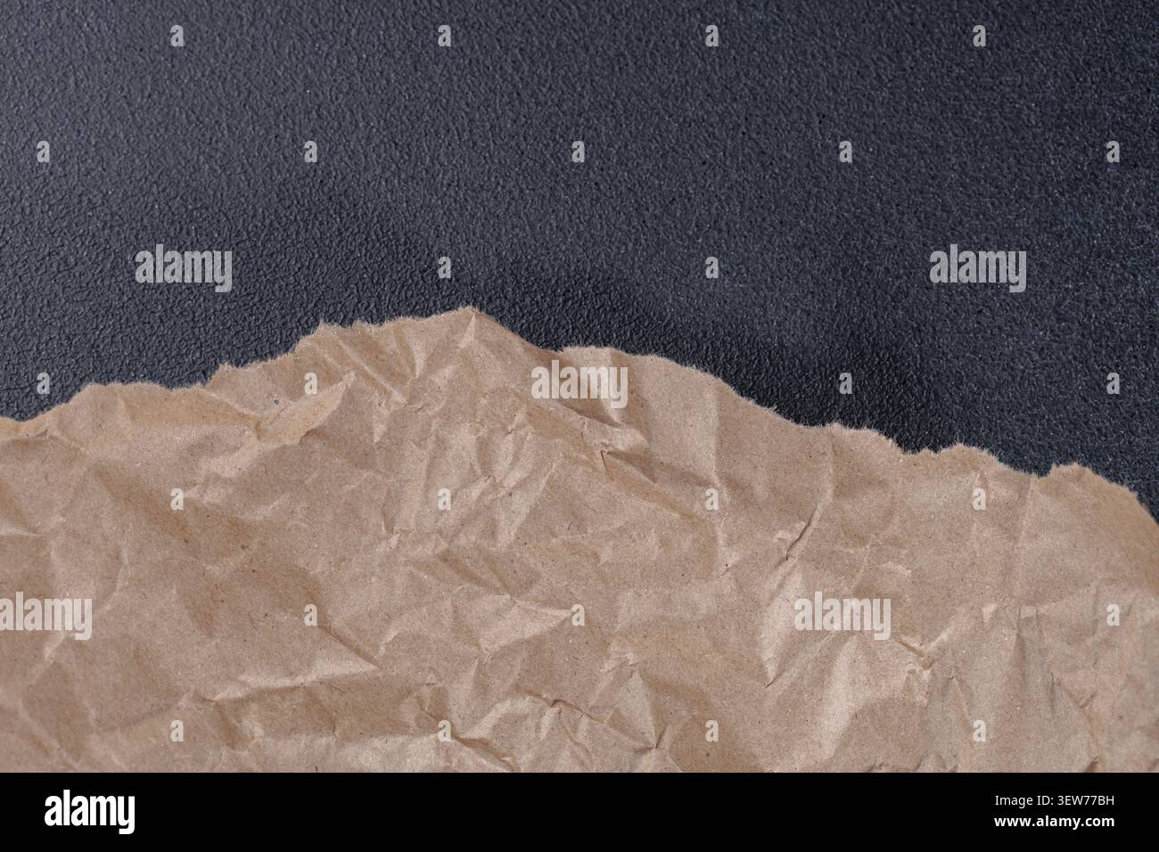 Brown Torn Kraft Paper Border on Black Background Stock Photo
