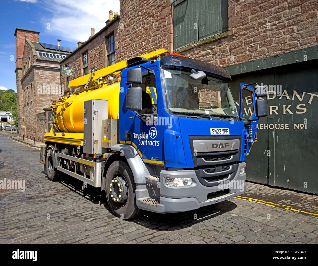 Tayside Contracts Municipal suction and jetting vehicle operating outside the historic Verdant Works jute-mill complex in central Dundee, Scotland Stock Photo