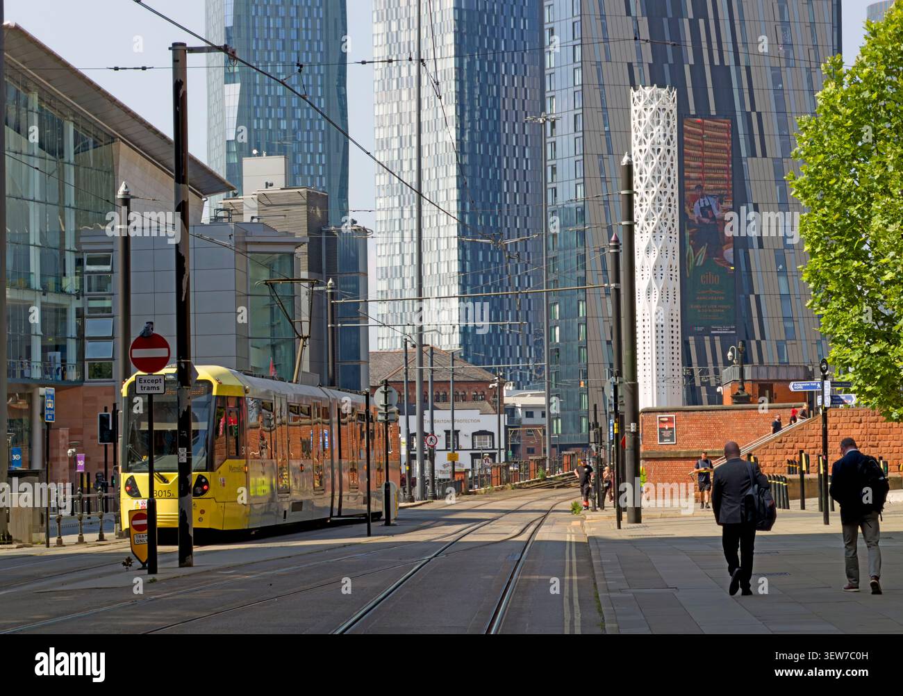 Bee network Metrolink tram on Lower Mosley Street, Manchester, framed by rising city-centre towers in the Andy Burnham mayoral era Stock Photo
