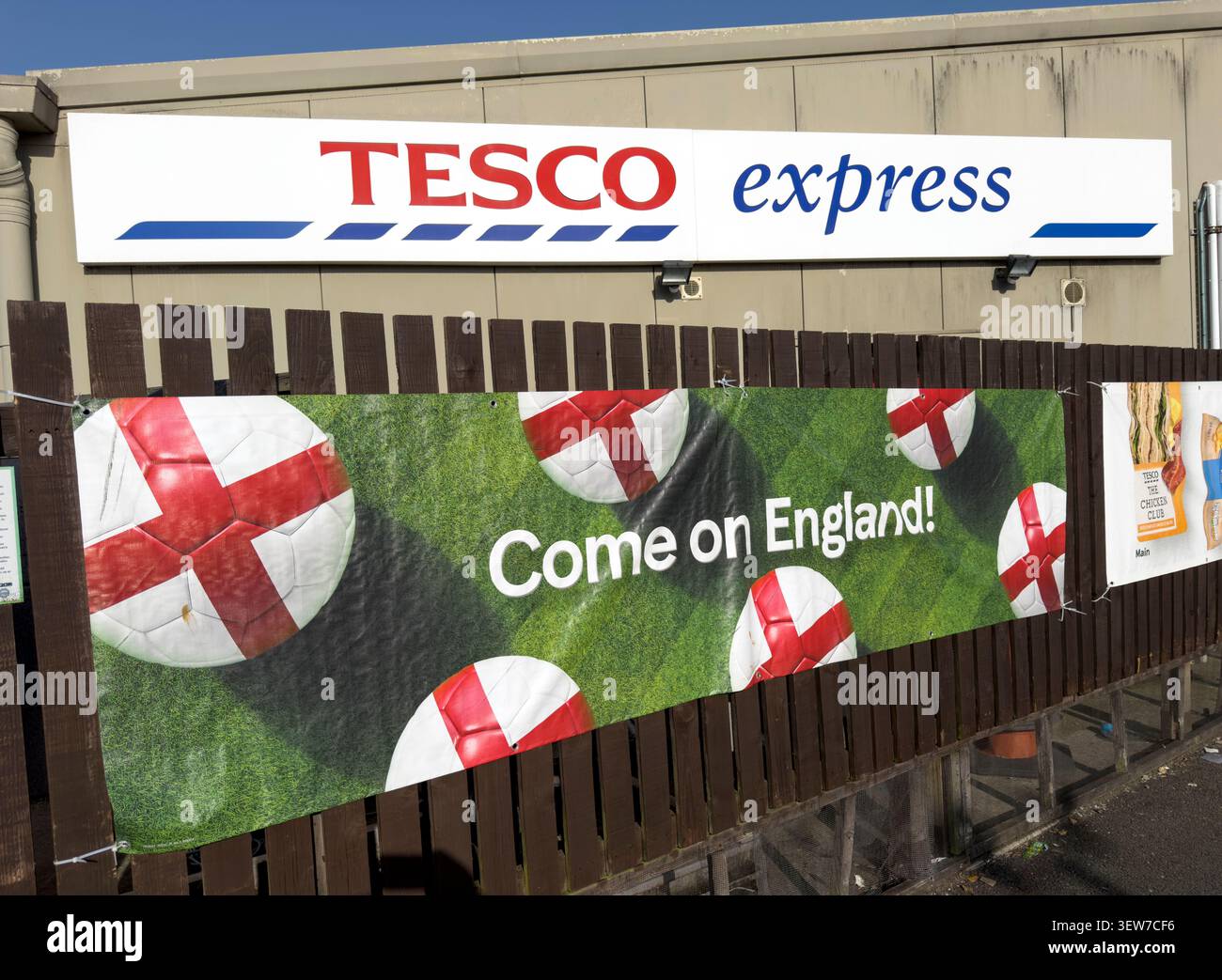 Tesco Express store in Grappenhall, Warrington, with Come On England banner, Cross of St George flag Stock Photo