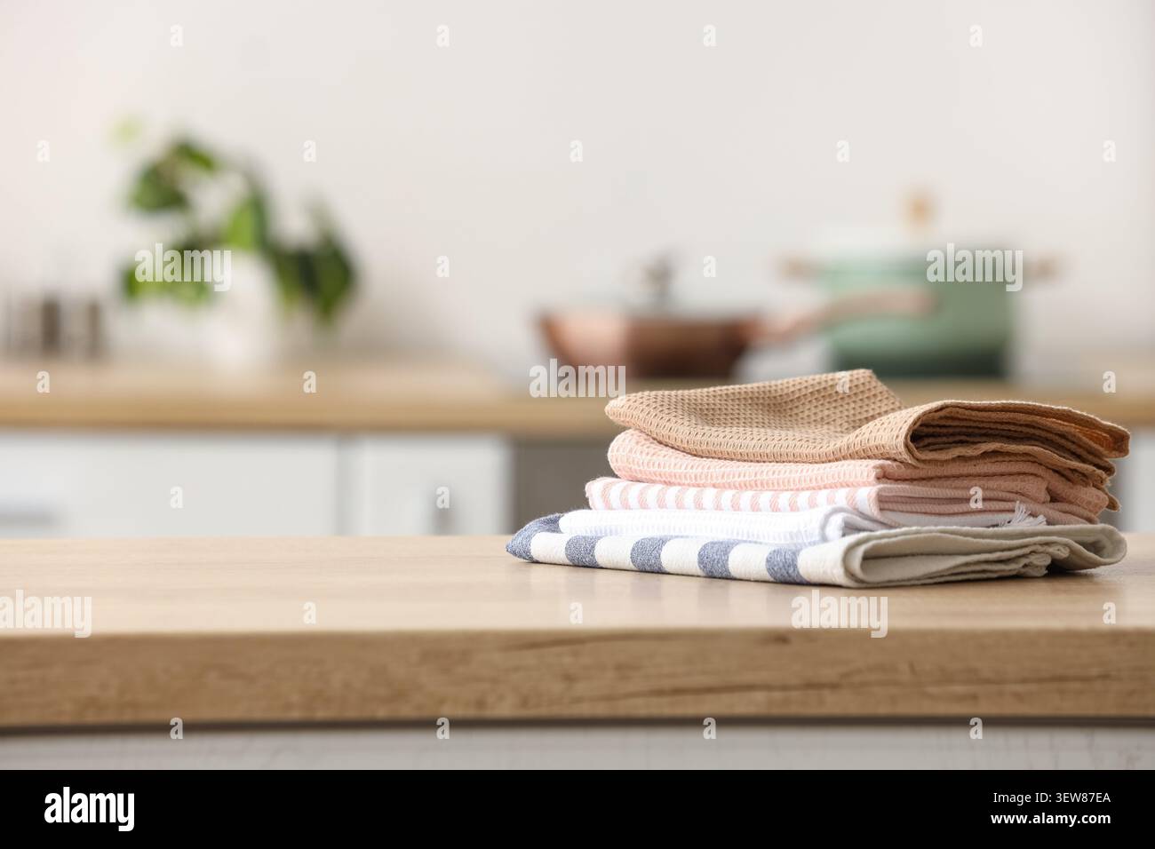 Stack of kitchen towels on wooden countertop Stock Photo