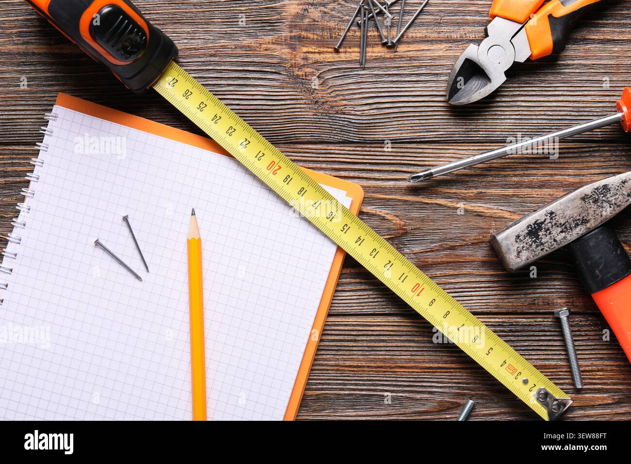 Construction tools and notebook on wooden table Stock Photo