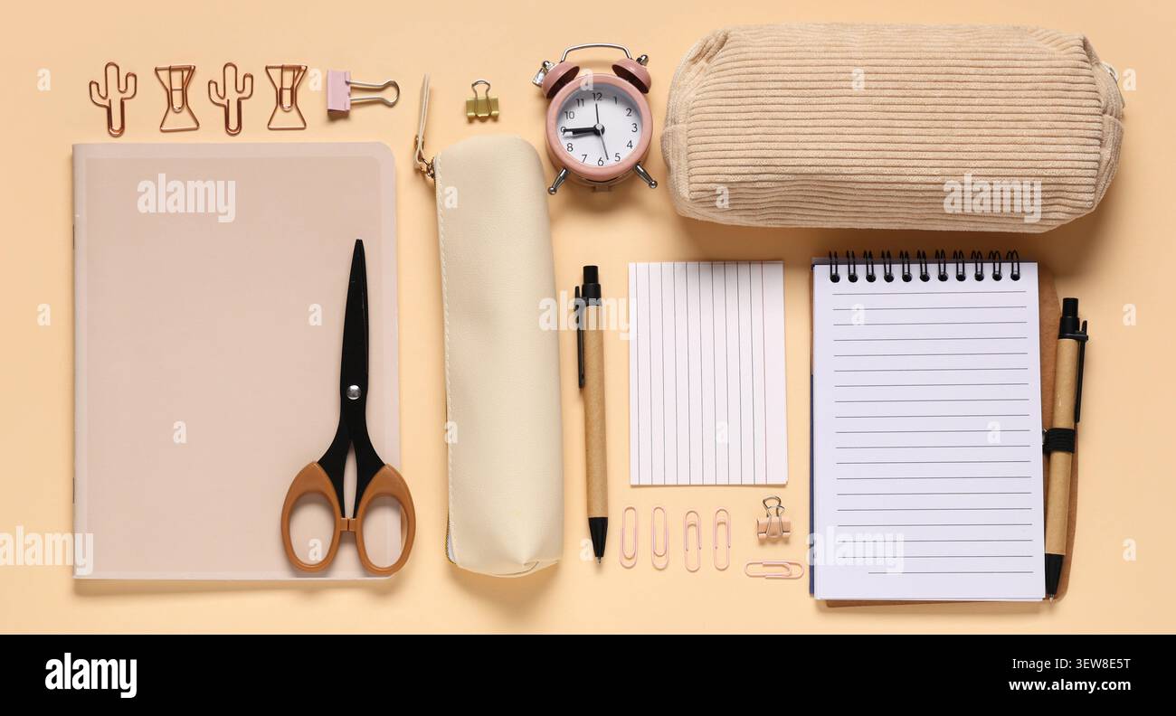 Flat lay of beige stationery and office supplies on peach background Stock Photo
