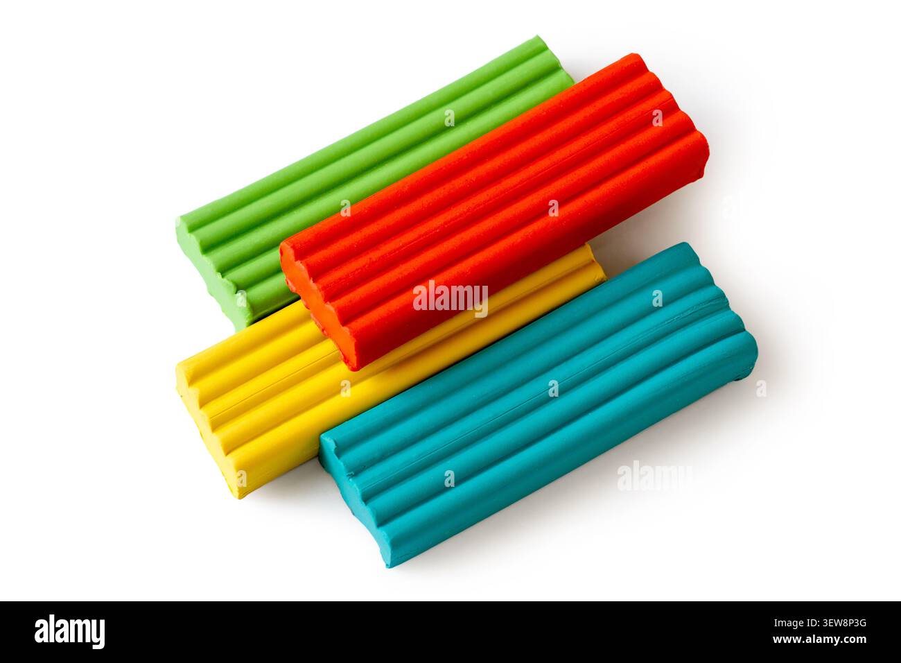 Multi-colored plasticine bricks on a white background. Childrens plasticine close-up. Stock Photo