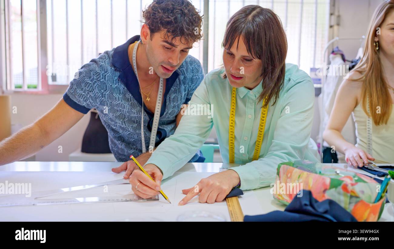 Fashion students learning pattern making in workshop Stock Photo