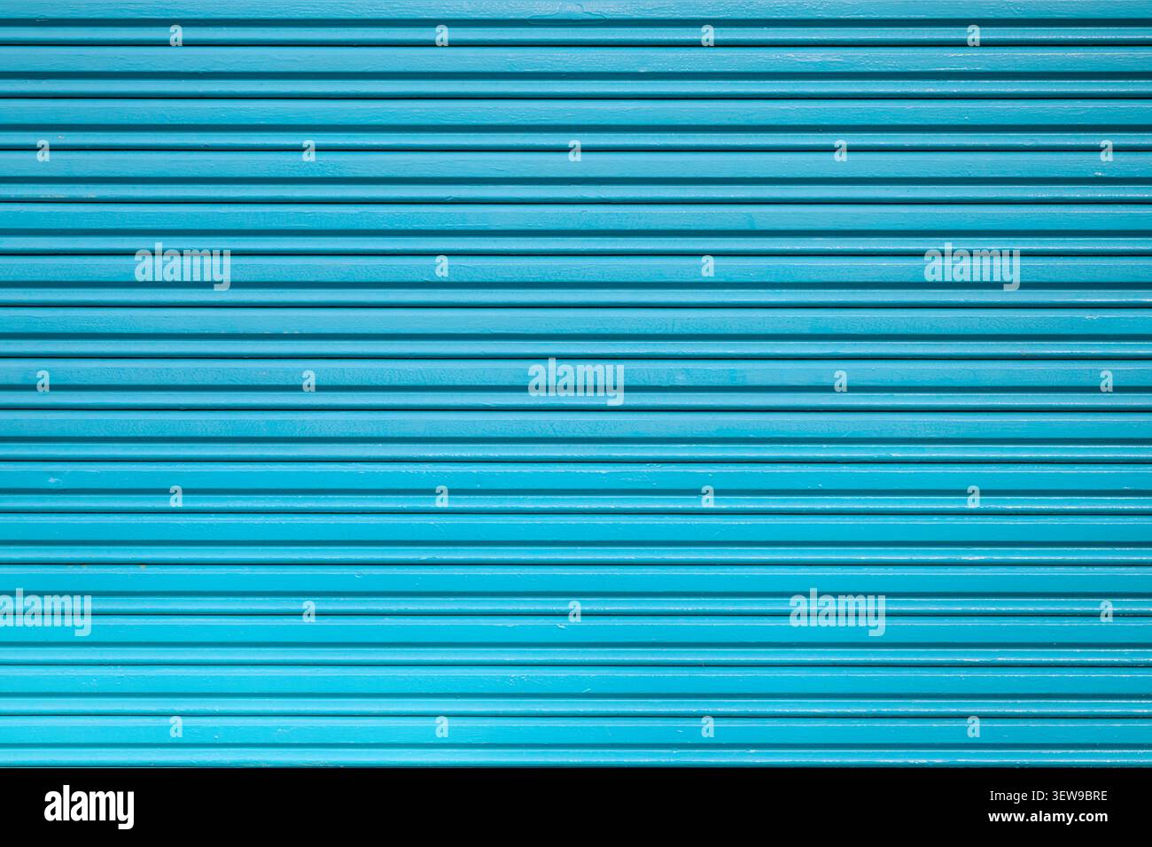 Front view background of a corrugated metal door with a roller shutter texture. Security concept for warehouse and garage entrances. Stock Photo