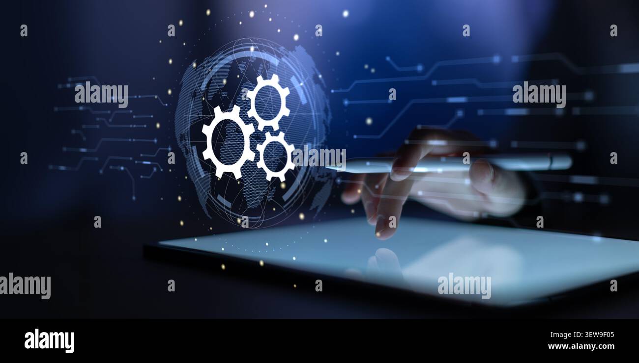 Hand interacting with a digital interface featuring gear icons representing automation and workflow processes Stock Photo