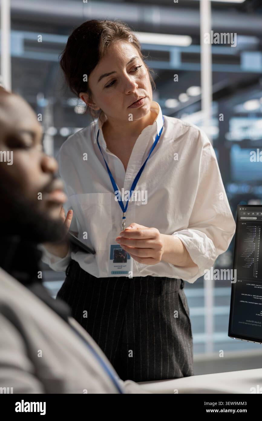 Engineering team uses a desktop computer in a data center to deploy software updates, configure hardware, and support reliable operations. Stock Photo