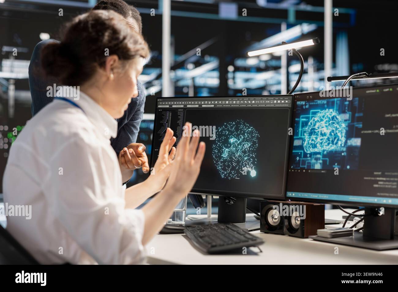 Data center colleagues collaborate on coding and AI automation scripts while reviewing server infrastructure together. Stock Photo