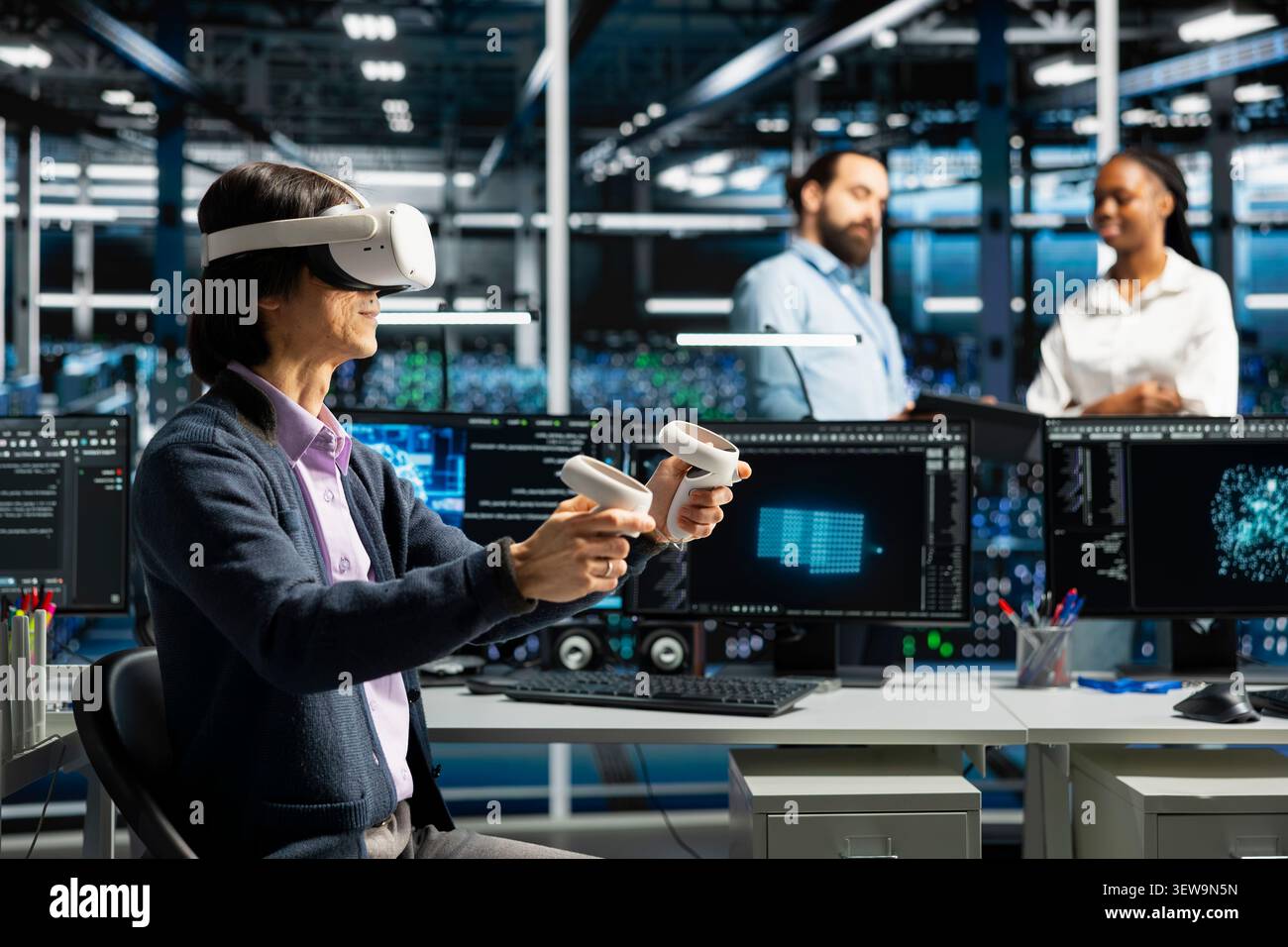 Data center programmer uses a VR headset to analyze datasets and manage AI database workflows in a server room. Stock Photo