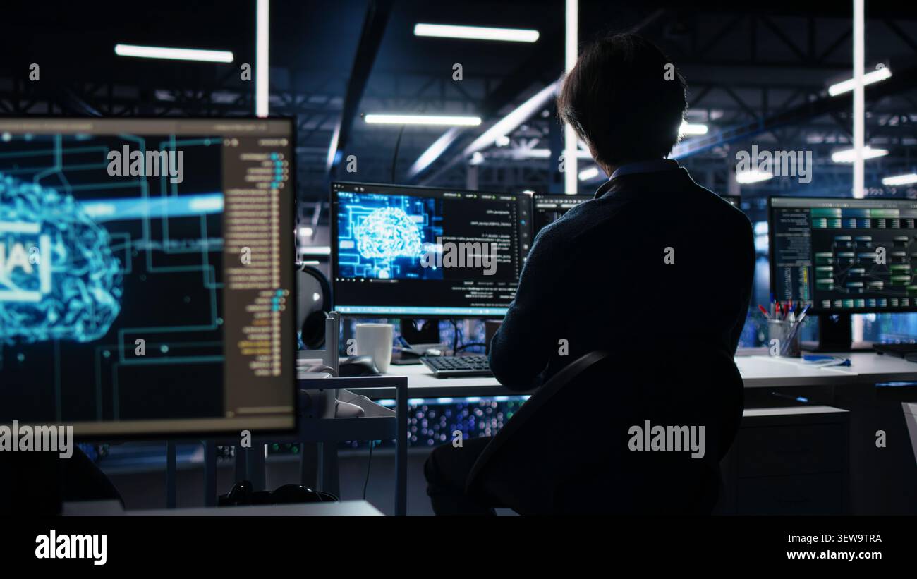 Data center engineer reviews artificial intelligence systems and machine learning processes inside a data center. Stock Photo