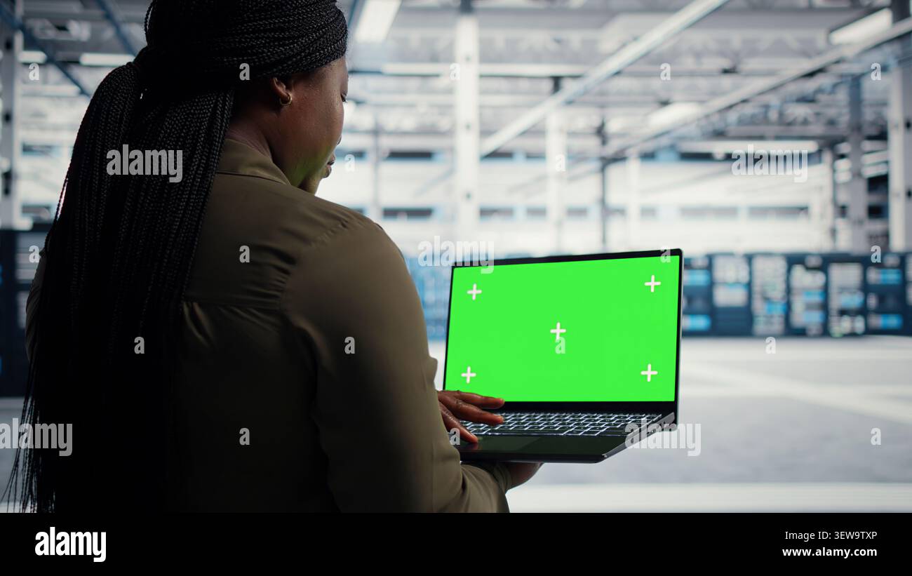 IT colleagues collaborate in a data center while reviewing AI diagnostics and infrastructure performance. Stock Photo