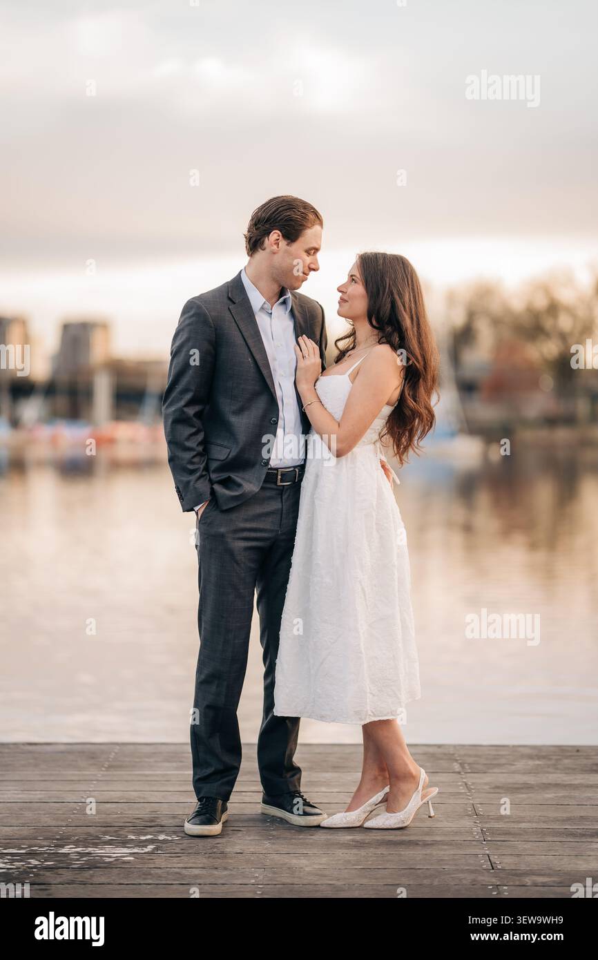Romantic couple gazing at each other on a dock Stock Photo
