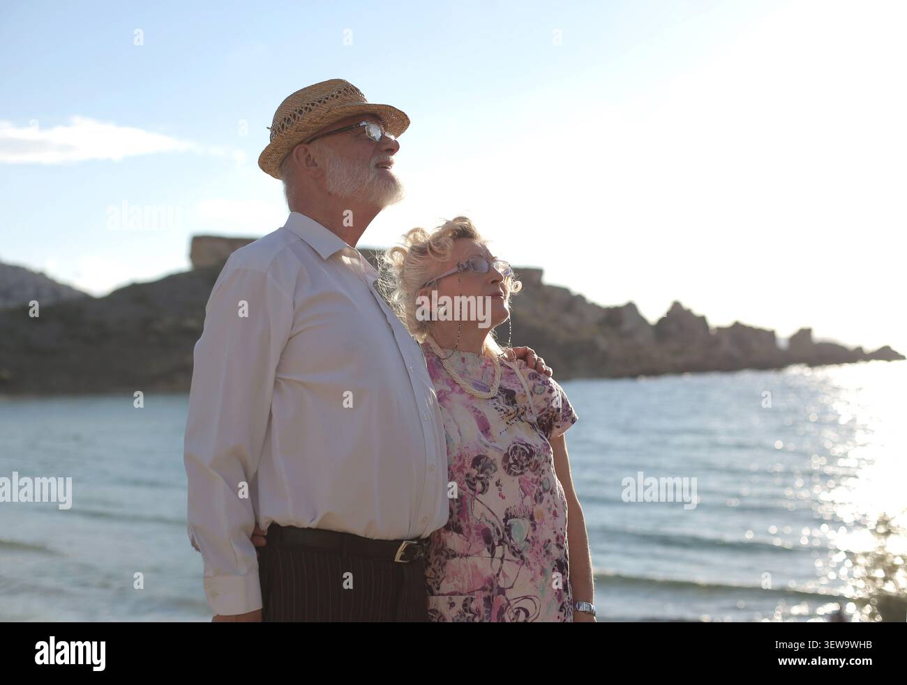 Senior couple enjoying a sunny day by the sea Stock Photo