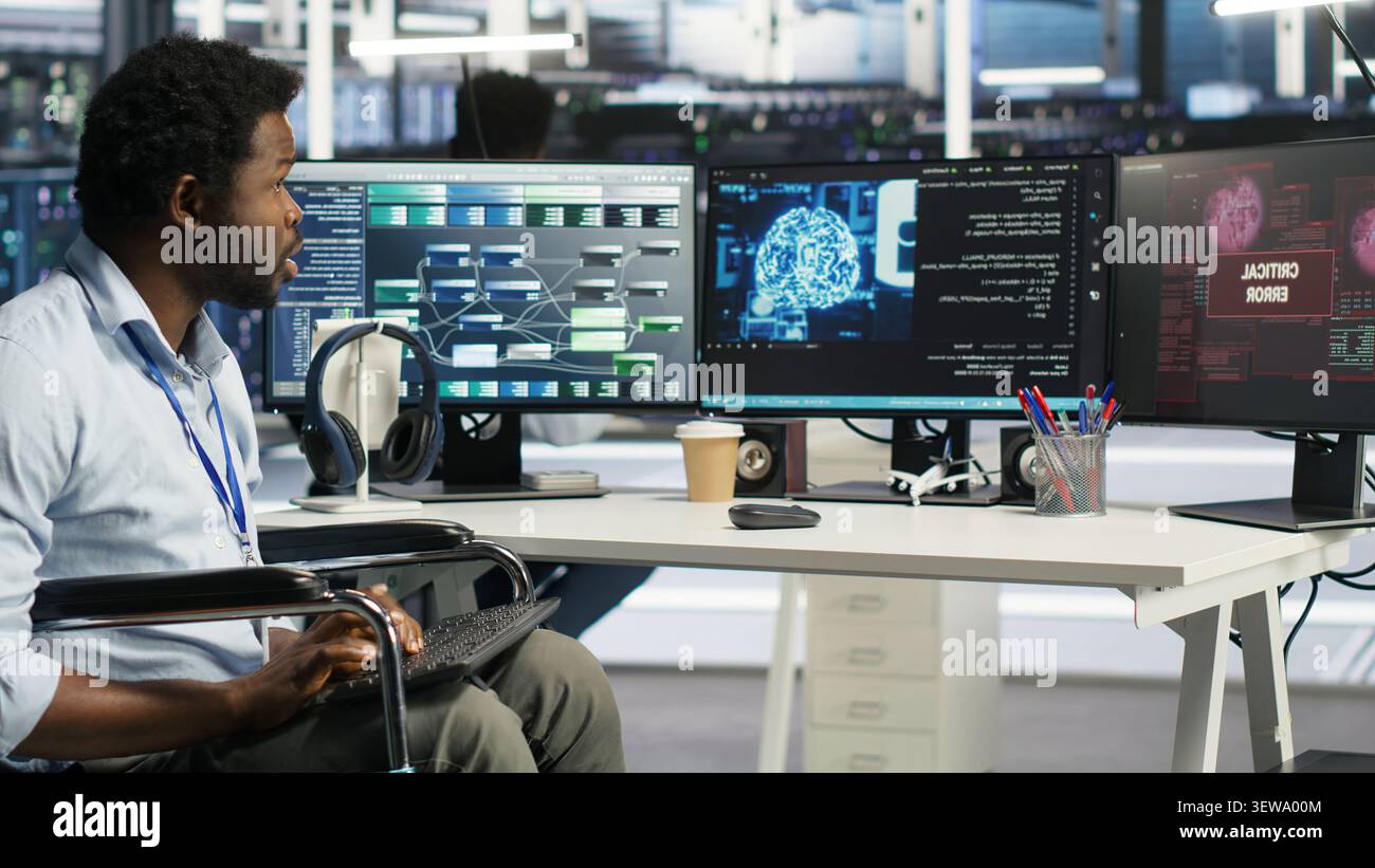 Engineer using a wheelchair reacts to a slow AI node tree tool while working in a data center. Stock Photo