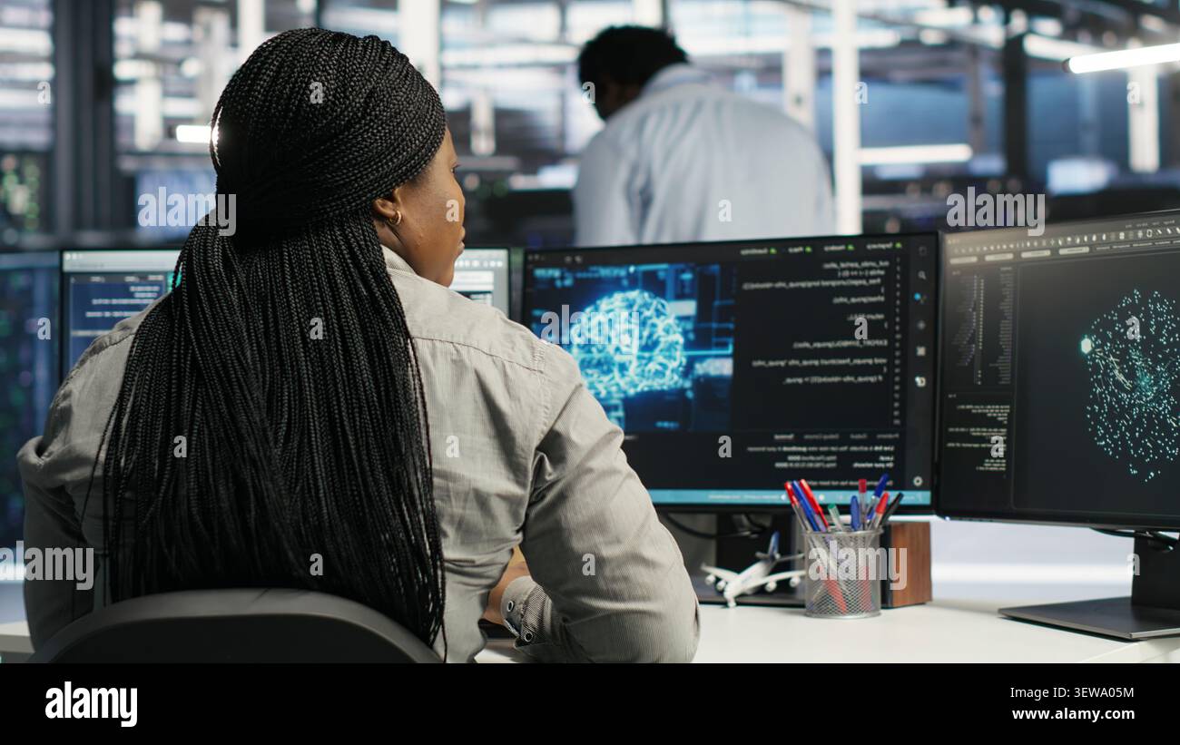 System administrator uses neural network node tree software to analyze infrastructure in a data center. Stock Photo