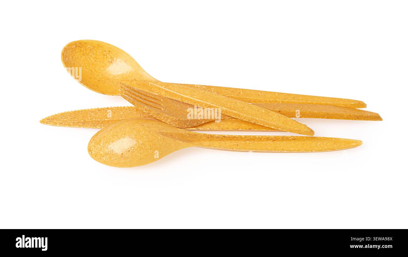 Yellow disposable fork, knife, and spoon placed on a transparent background Stock Photo