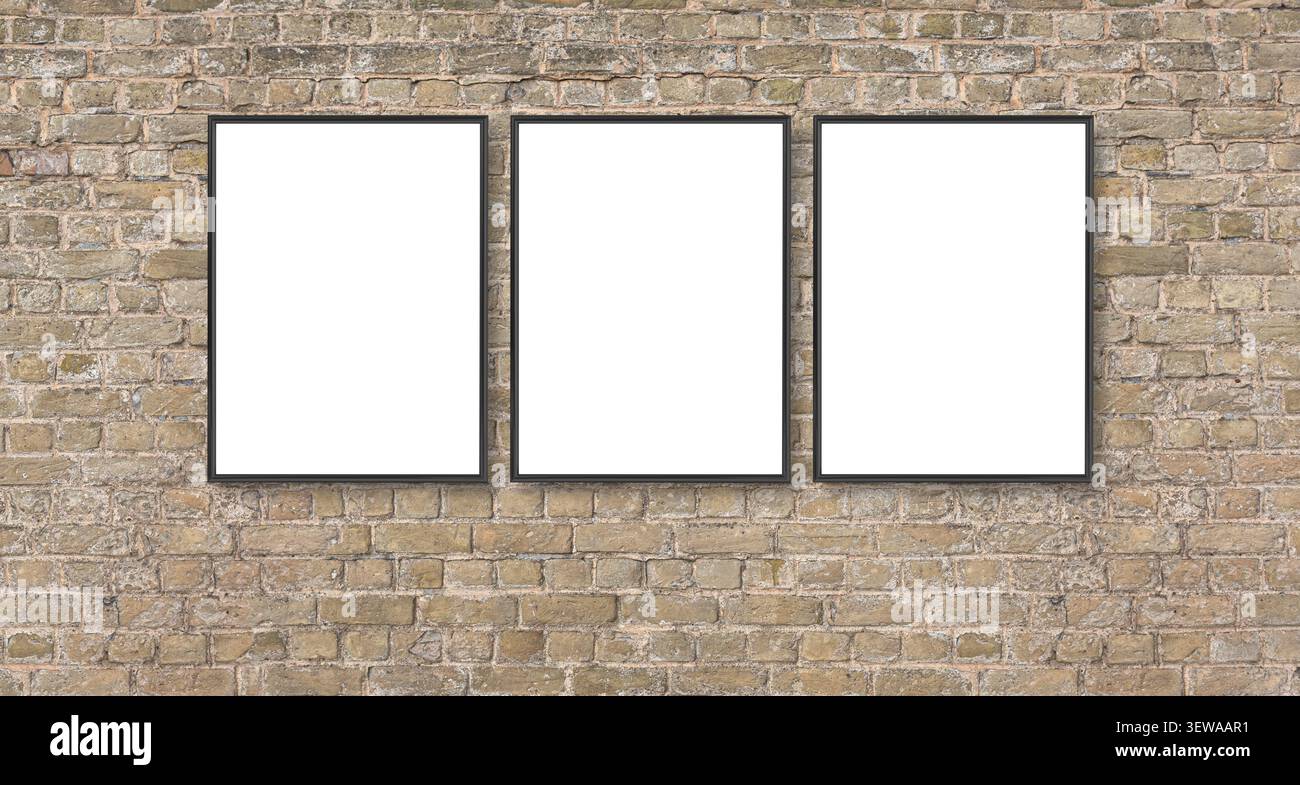 Three empty black frames displaying content on a weathered brick wall Stock Photo