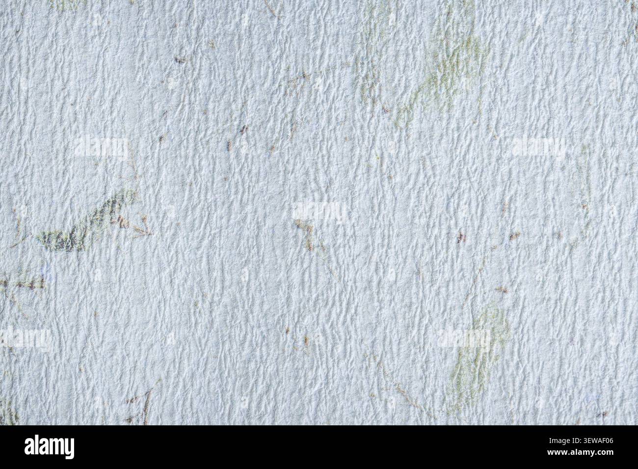 White handmade paper featuring a fine rippled surface and faint embedded botanical fibers, creating a soft organic background for design projects. Stock Photo
