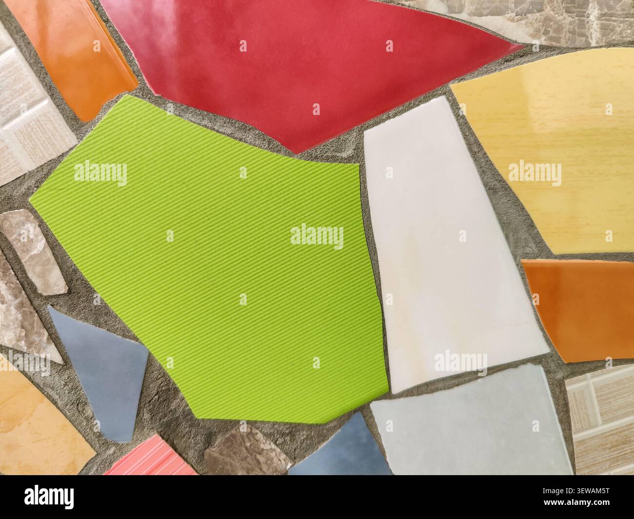 Vibrant Mosaic background Displaying Assemblage of Colored Tiles. Array of brightly colored and textured tiles arranged in captivating mosaic pattern. Stock Photo