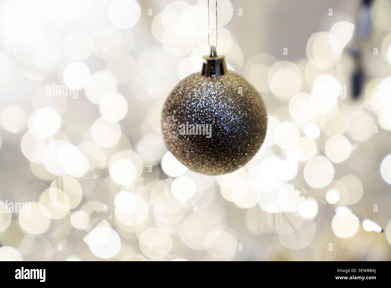 Festive Christmas tree composition decorated with baubles, bows, animal ornaments, glowing garlands. Cozy holiday decorations warm New Year atmosphere Stock Photo