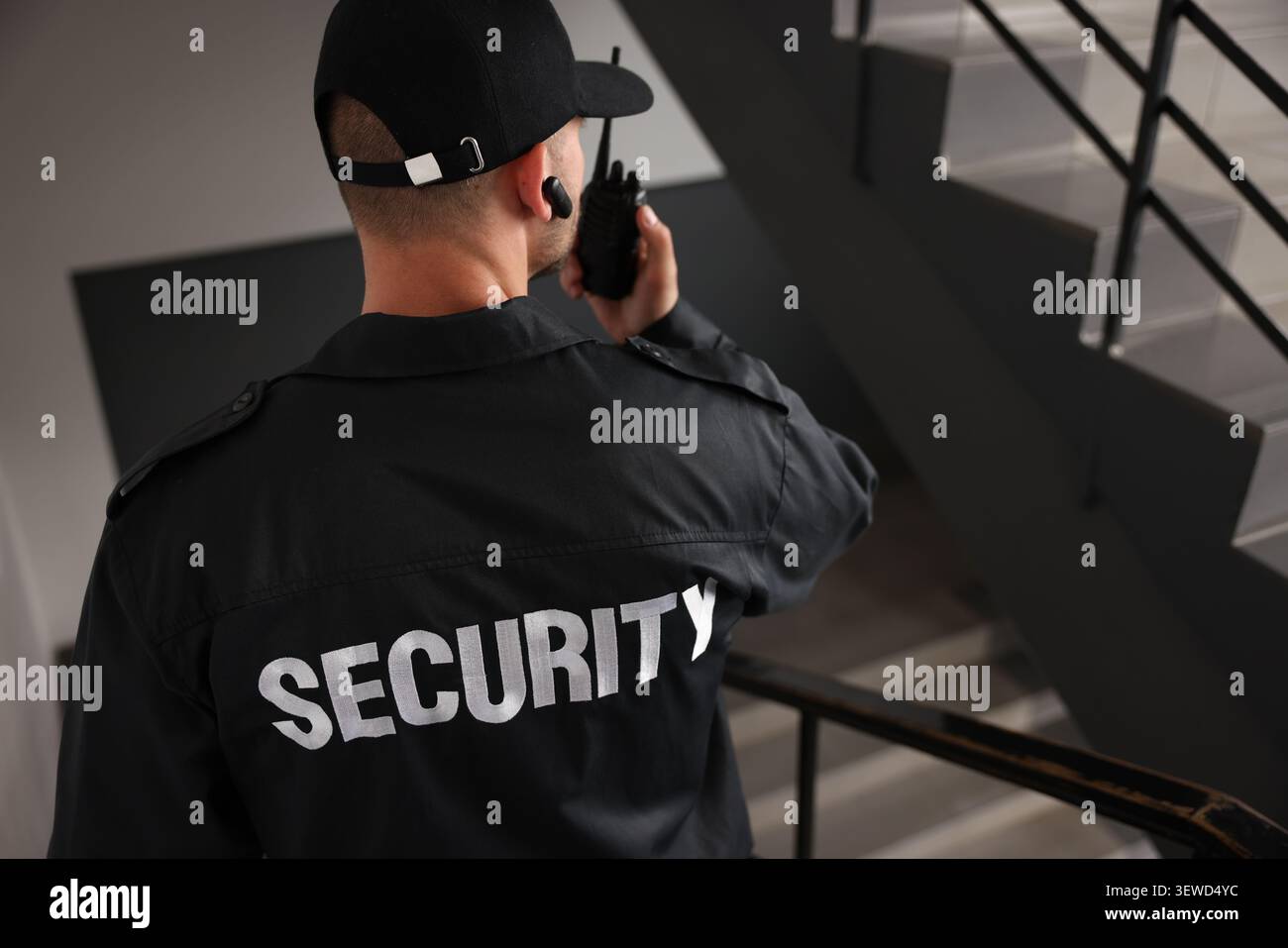 Bodyguard in uniform using walking down stairs Stock Photo