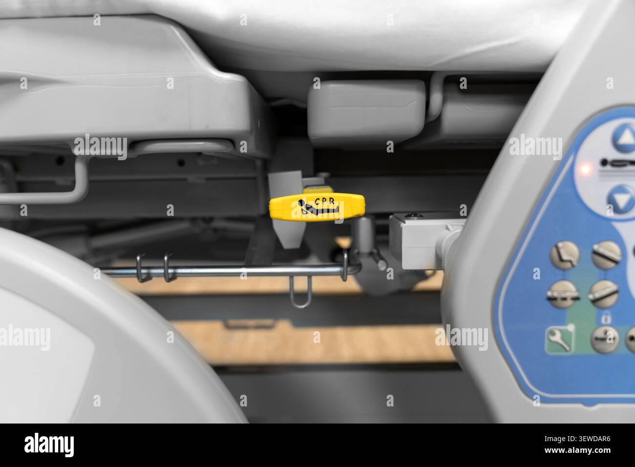 Hospital bed CPR release lever in a modern medical facility. Essential safety feature for emergency care and rapid life support response. Stock Photo