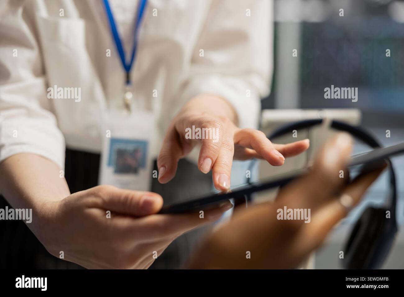Engineering team uses a digital tablet in a data center to run hardware diagnostics and maintain operational stability. Stock Photo