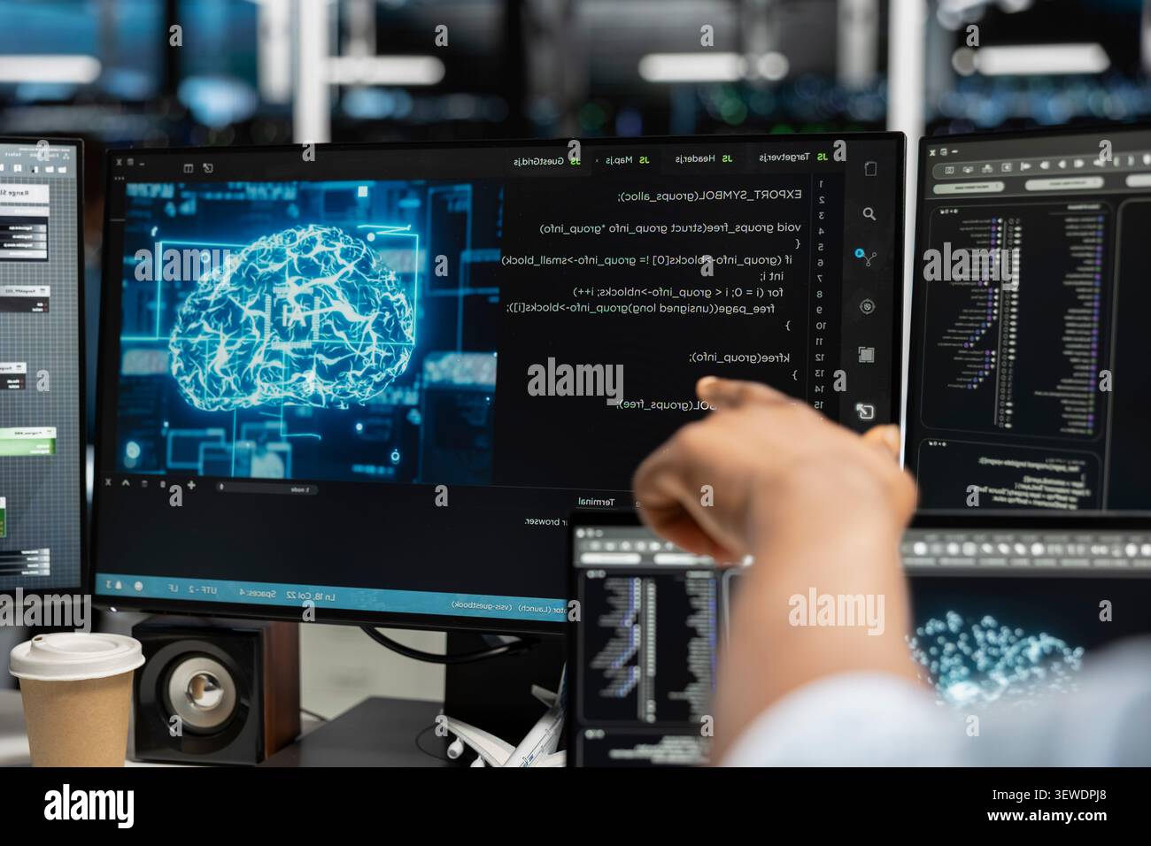 Computer scientist uses a desktop computer in a data center to manage AI systems and optimize server infrastructure. Stock Photo