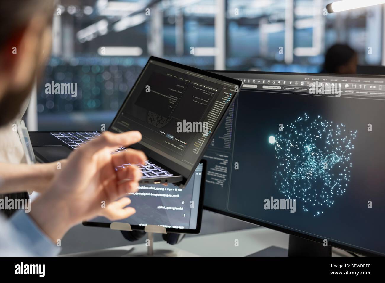 Software developer uses a tablet to run diagnostics, update servers and check infrastructure performance. Stock Photo